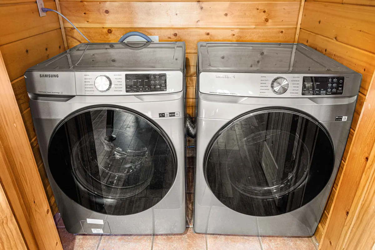 A practical laundry room equipped with a washer and dryer. The space is functional and streamlined, designed to make daily chores easier for guests during their stay.